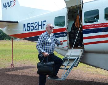 Jonathan Greenham boarding MAF aircraft from Harper.